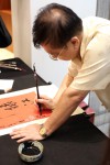 Traditional Chinese Calligraphy artist personalising scrolls for the guests