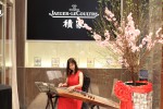 oriental soloist serenading some beautiful pieces on a traditional GuZheng musical instrument 2