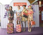 Models striking a pose with the exclusive Guardian x Anna Sui travel bags collection